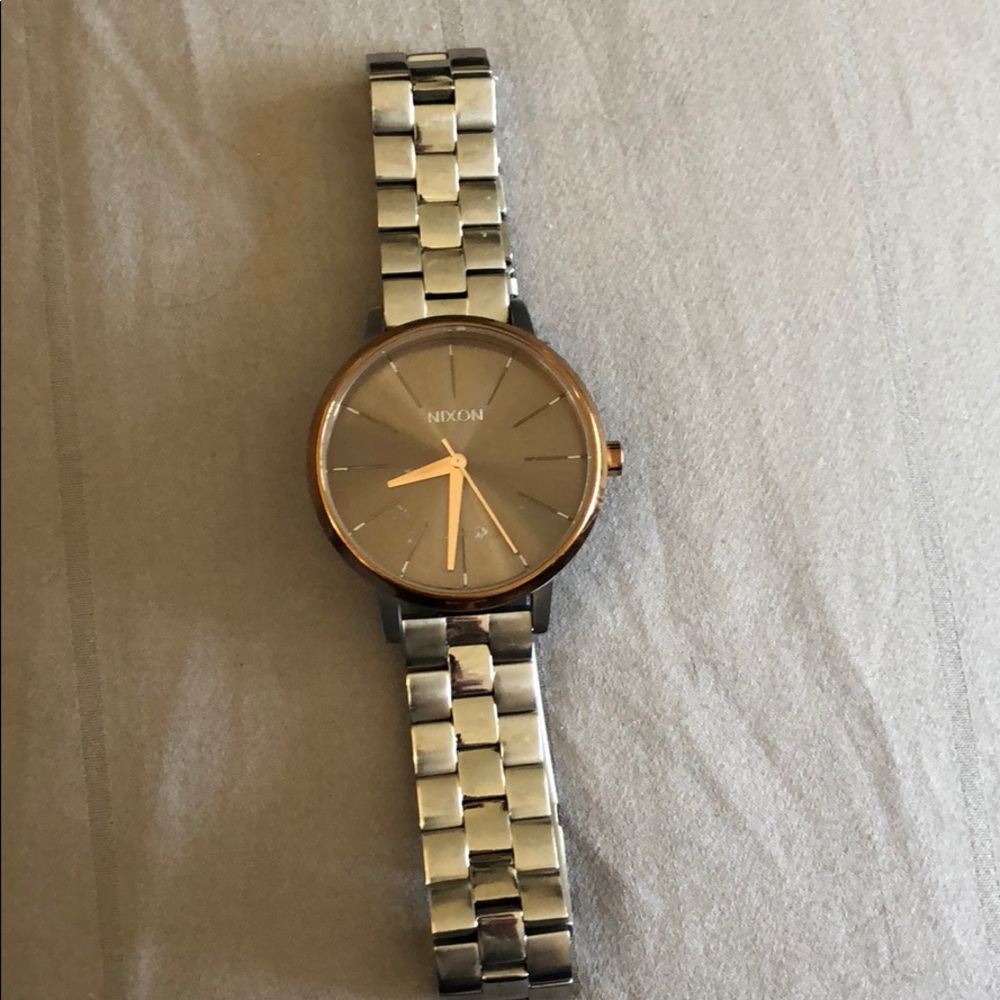 - Nixon watch silver with lining gold on silver face